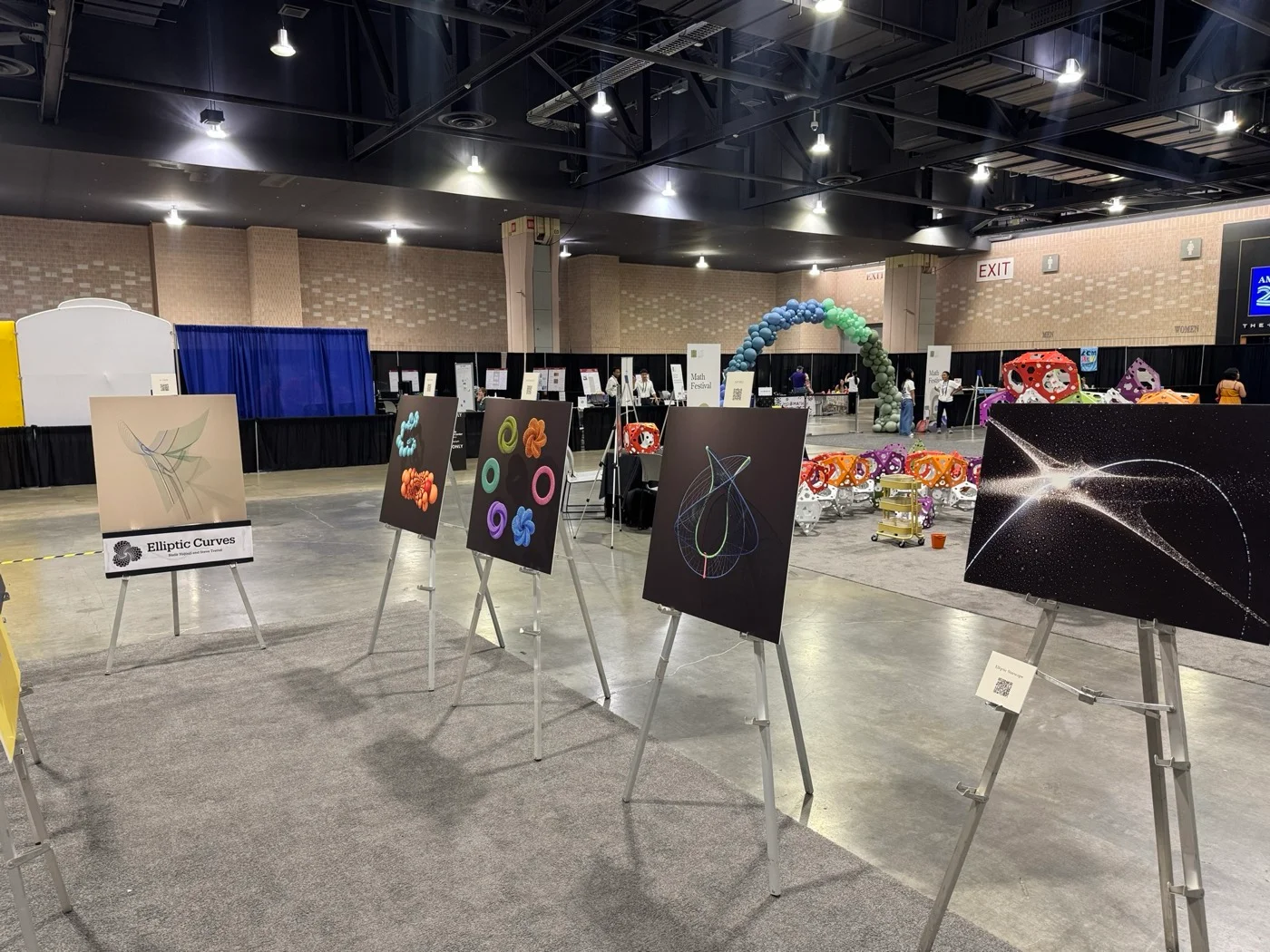 The Elliptic Curves group at the ICM art exhibition, with its title placard, alongside the Elliptic Starscape.