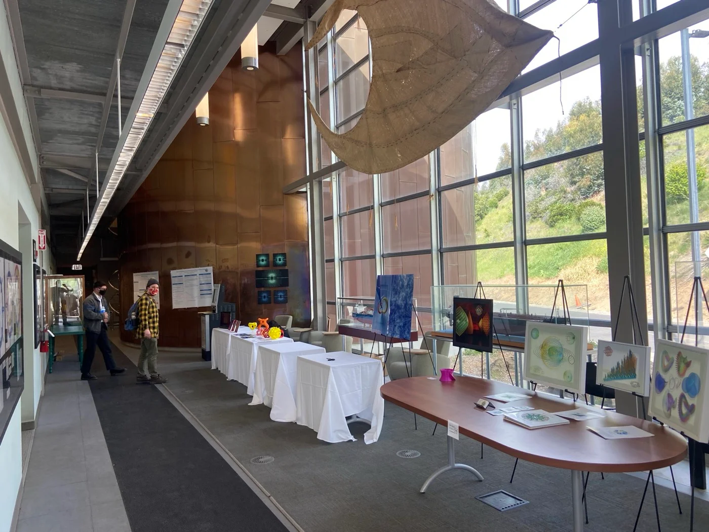 The art exhibition at the Golden Section meeting, hosted by the California State University Maritime Academy. The four panels of The Geometry of Knot Complements hang on the copper wall at left.