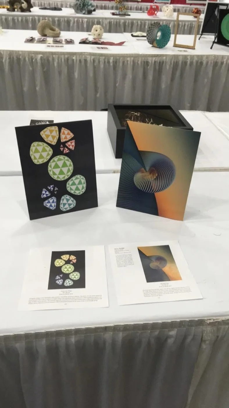 Triangle Symmetry and Hopf on the exhibition table in Baltimore, with their catalogue pages.